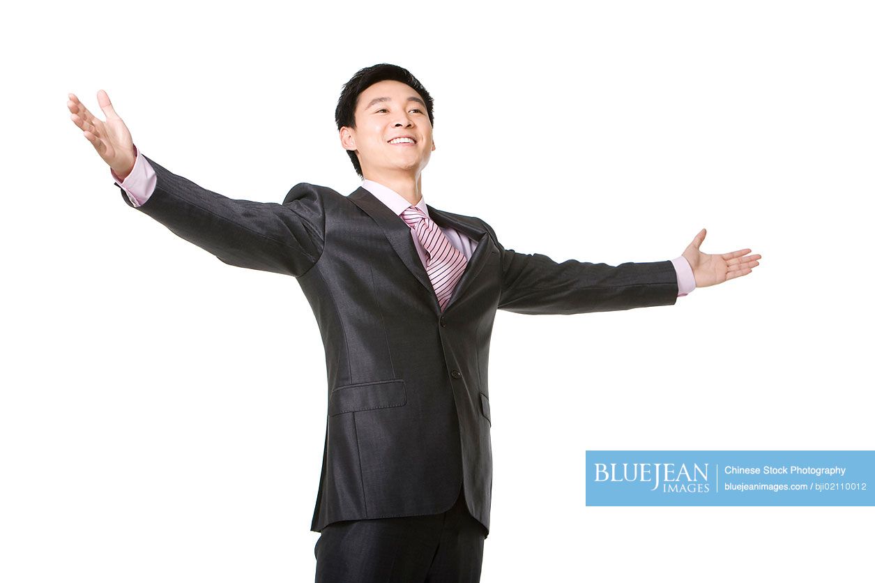 Waist up of Chinese businessman with arms outstretched