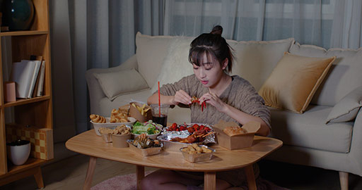 Young Chinese woman eating take-out food at night,4K