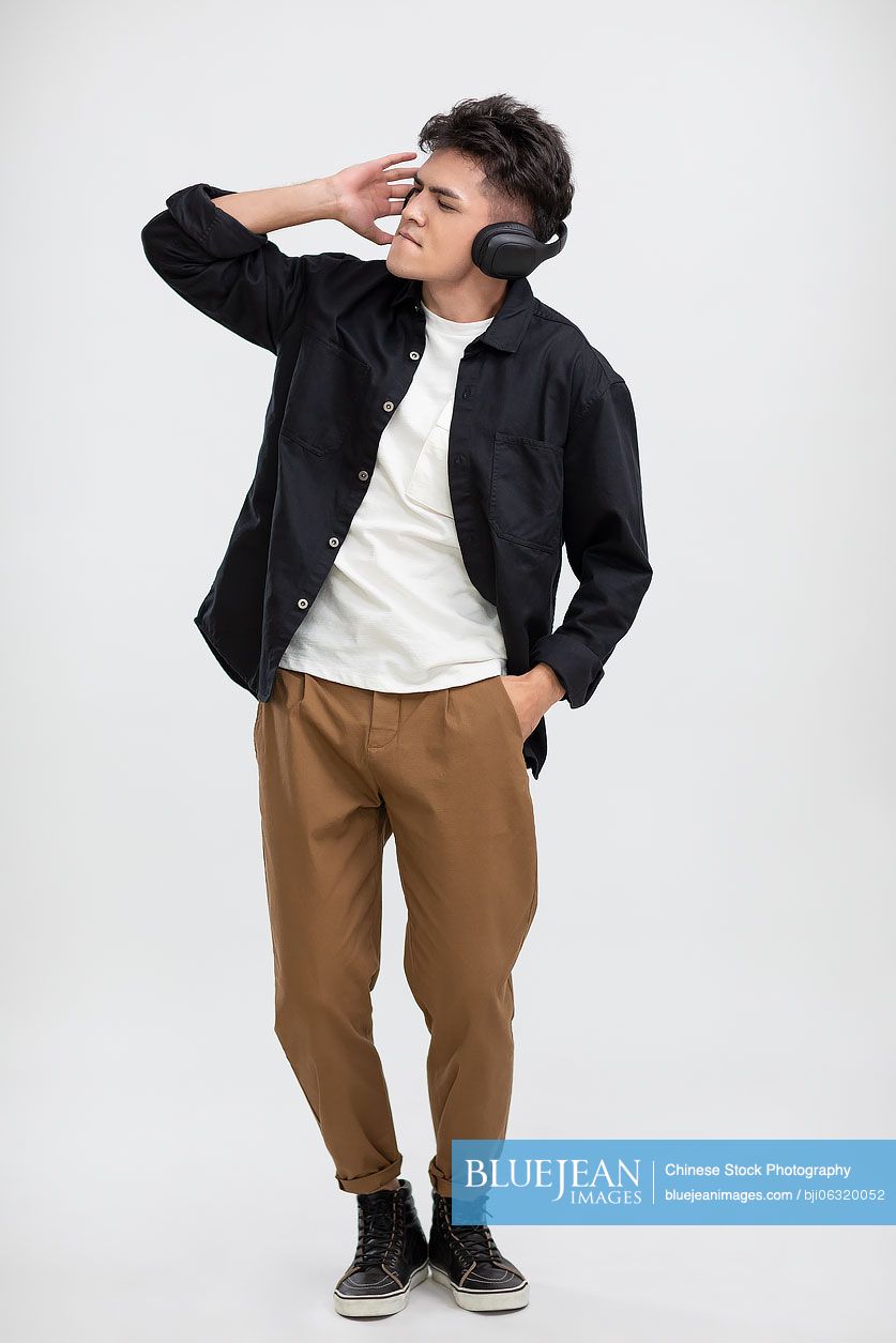 Cool young Chinese man wearing headphones