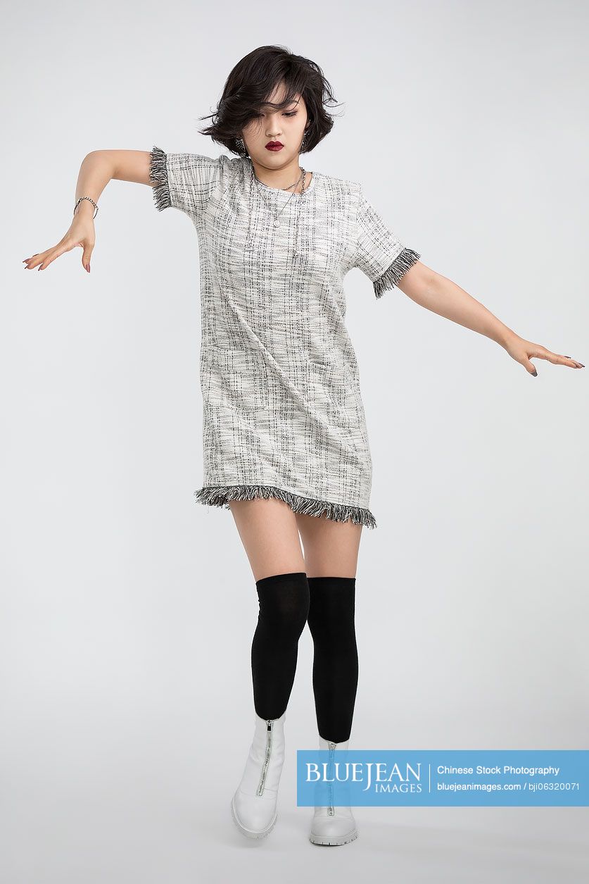 Cool young Chinese woman dancing