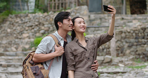 Young Chinese couple taking selfie outdoors,4K