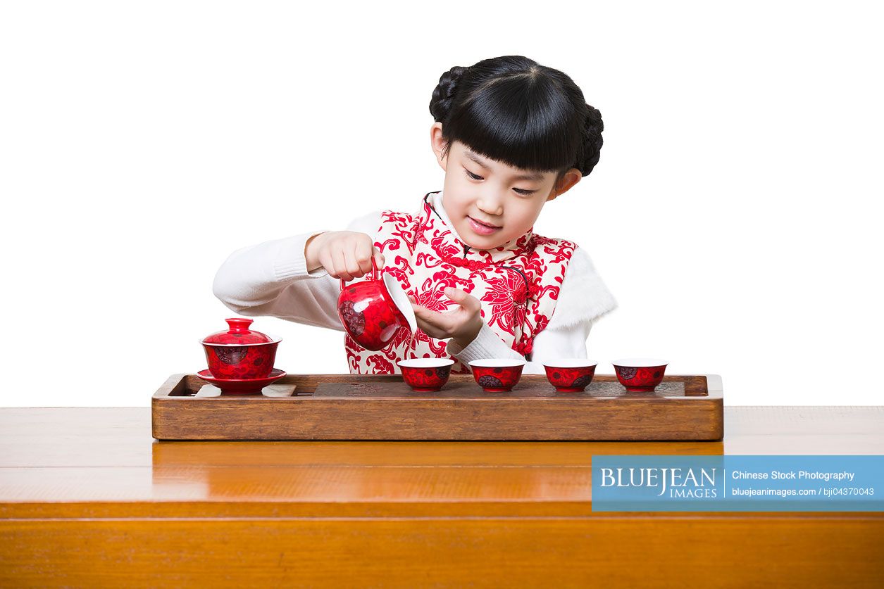 Happy Chinese girl performing tea ceremony