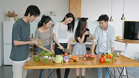 Young Chinese friends cooking in kitchen,4K