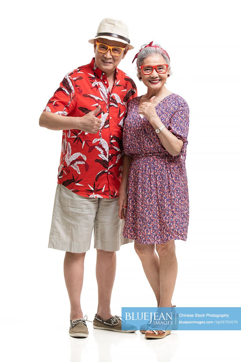 Happy senior Chinese couple doing thumbs up