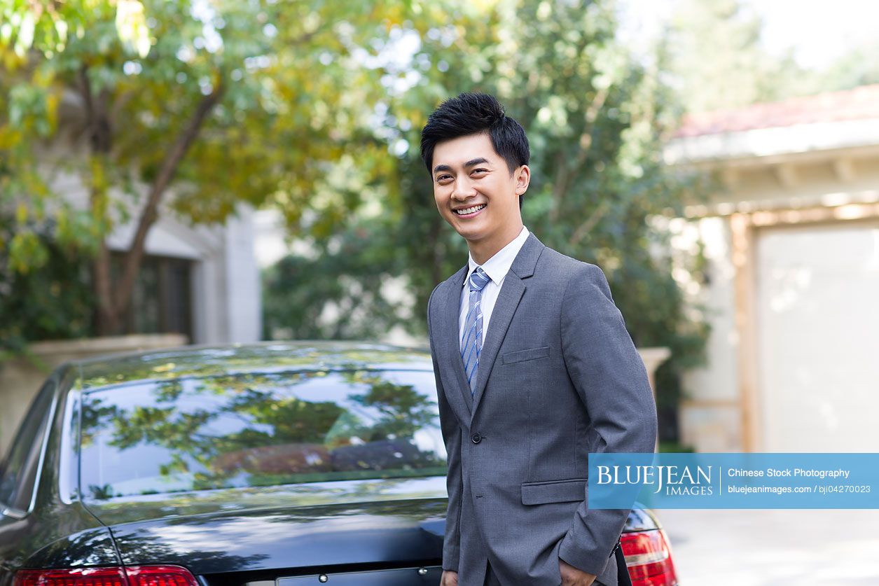 Young Chinese businessman and car