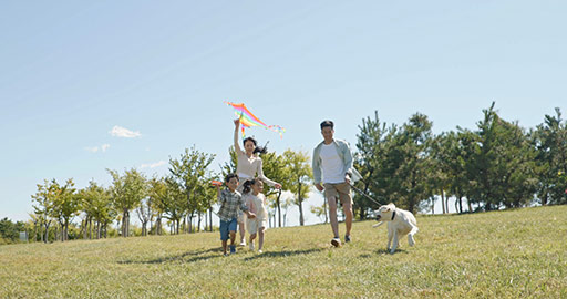 Happy Chinese family running with kite on meadow,4K