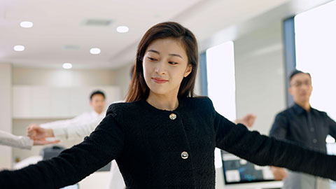 Chinese business people exercising in office