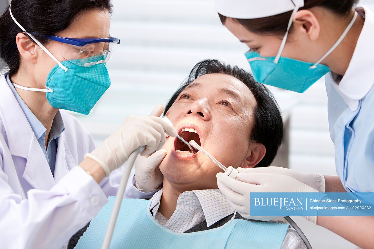 Chinese patient receiving treatment in dental clinic