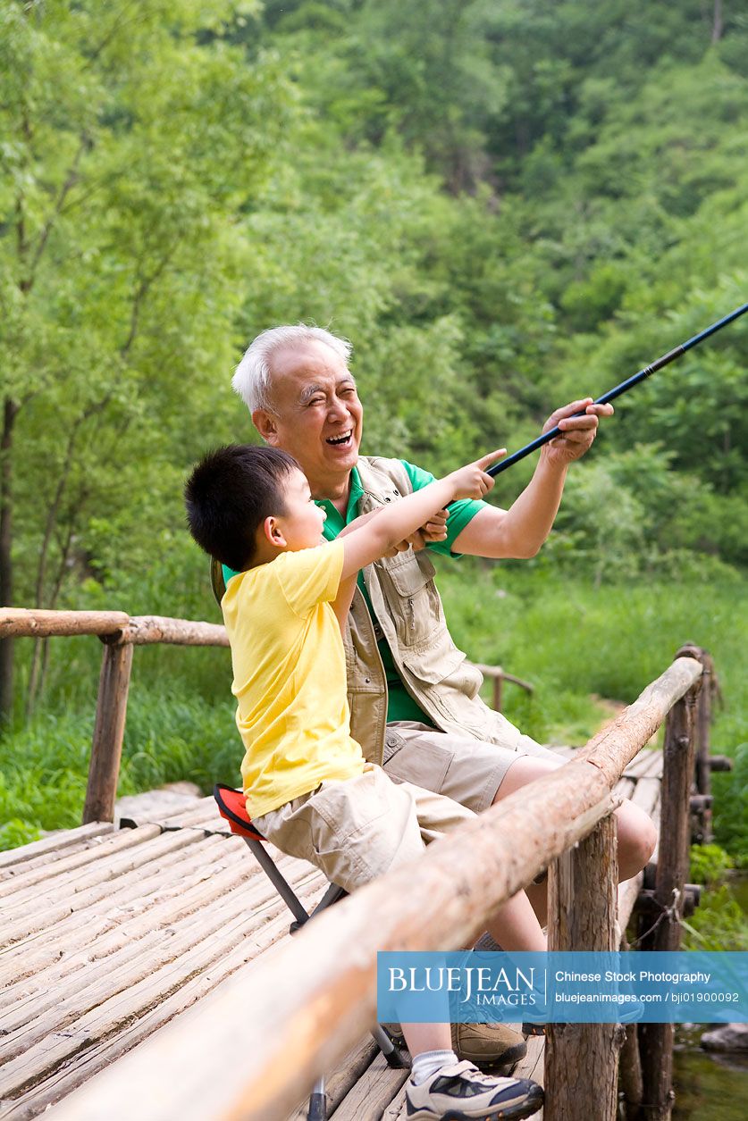 Chinese grandfather and grandson fishing-High-res stock photo for download