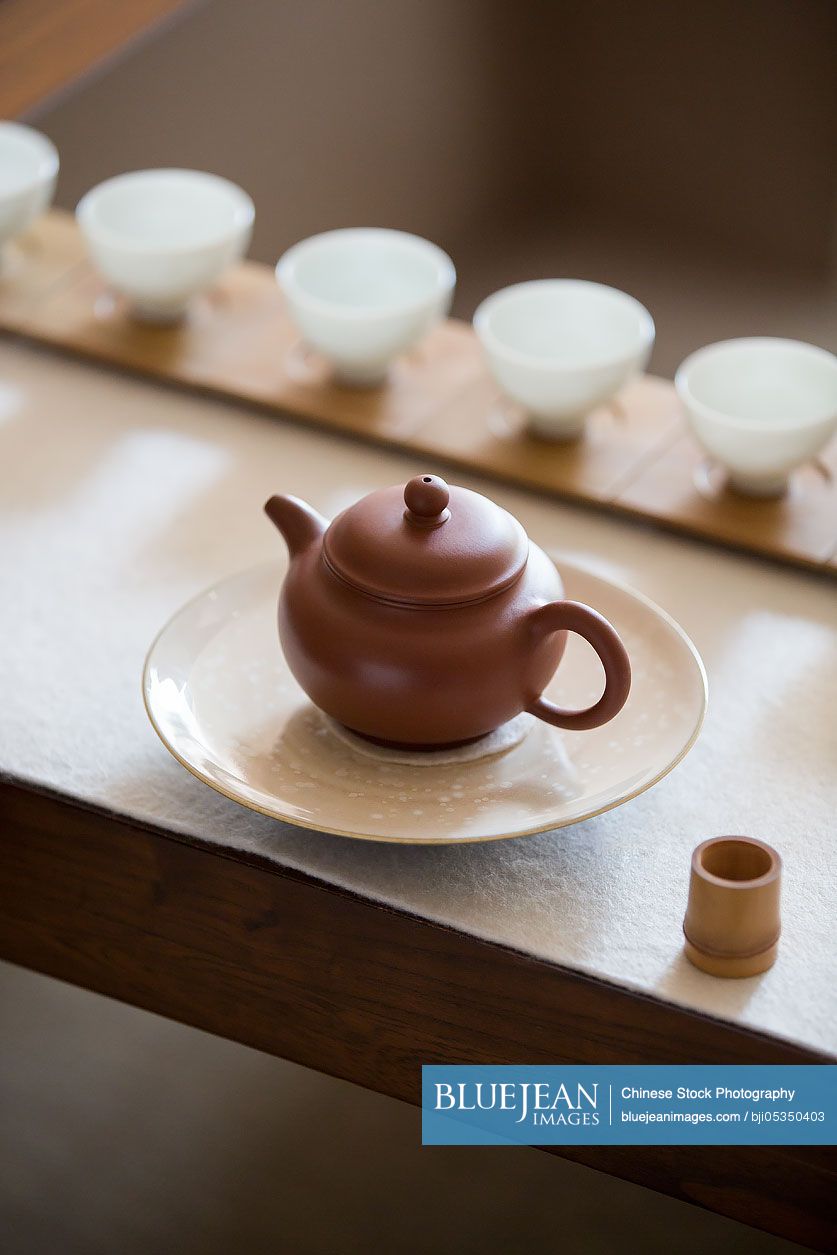 Tea pot and tea cups in tea room
