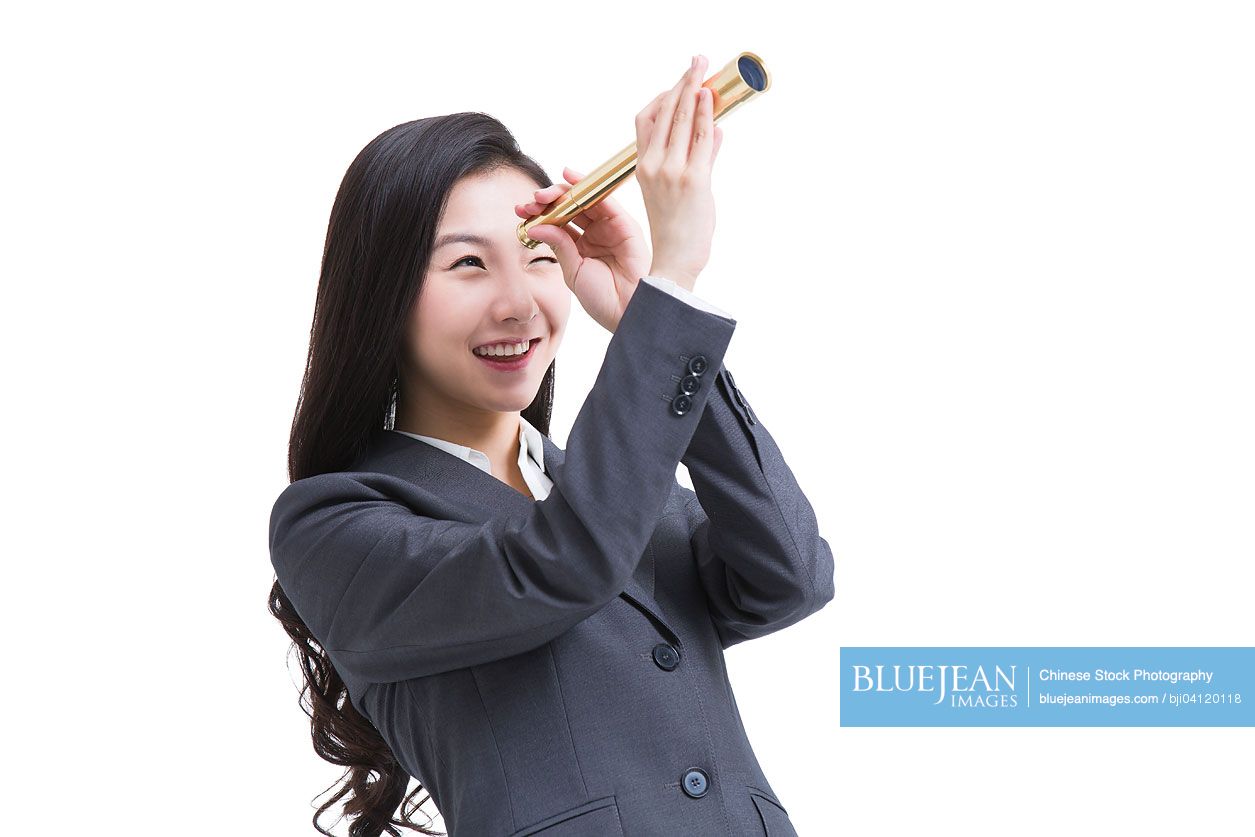 Chinese businesswoman looking through telescope