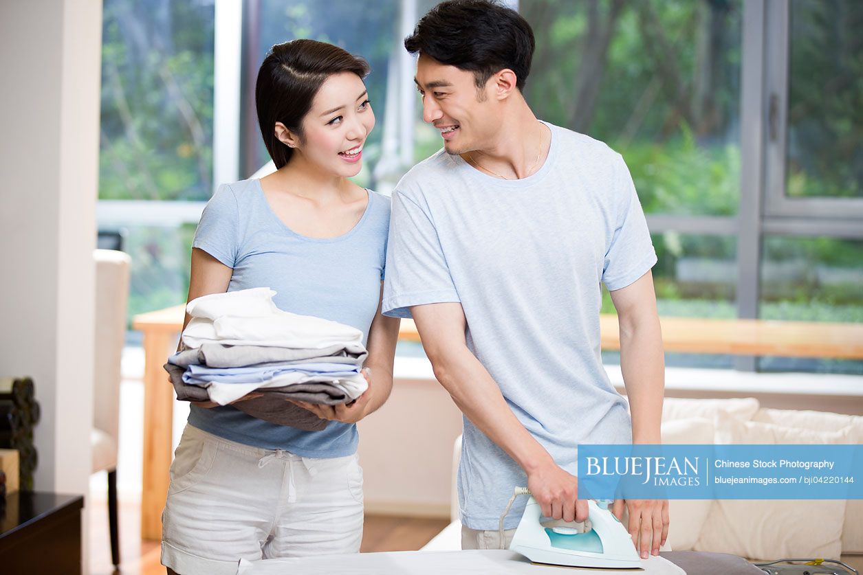 Young Chinese couple doing housework