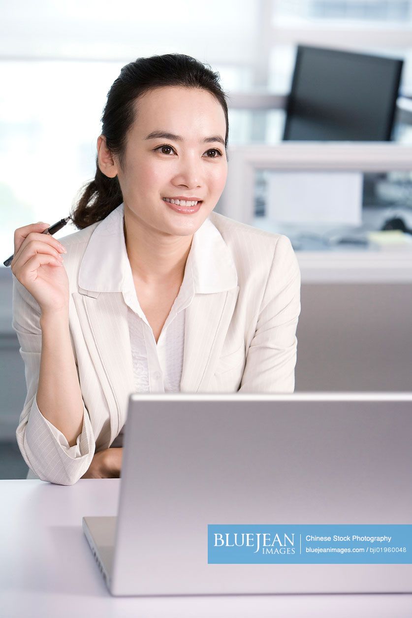 Chinese office worker at her desk
