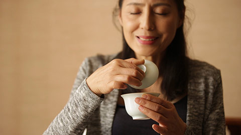 Happy mature Chinese woman drinking tea,HD