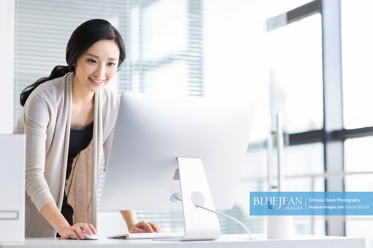 Young Chinese woman working in office