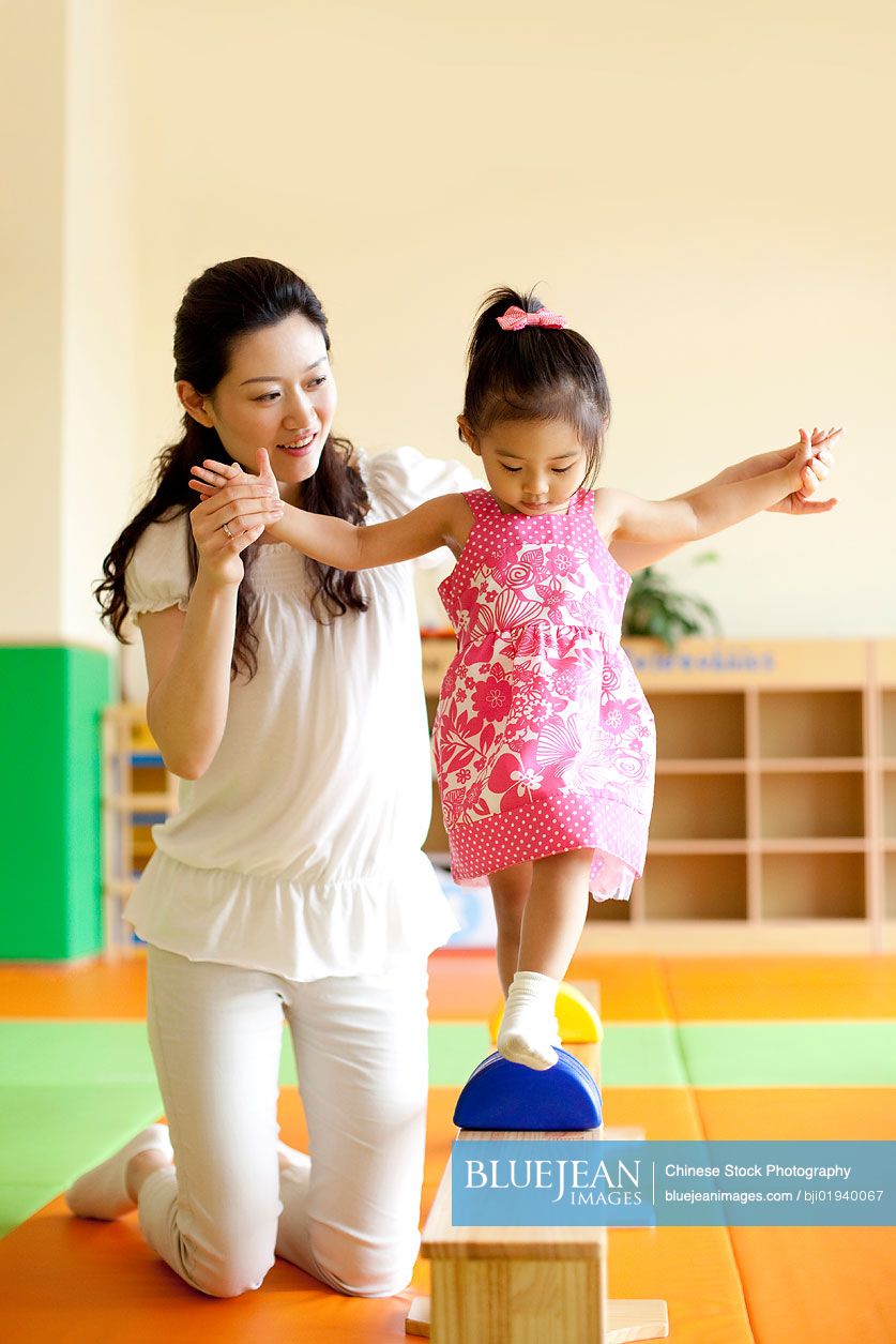 Chinese mother playing with daughter