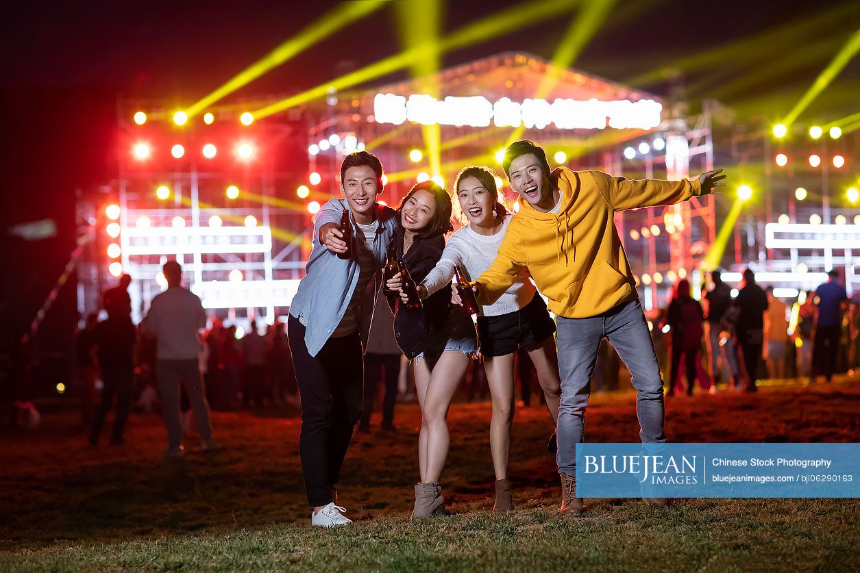 Happy young Chinese friends at music festival
