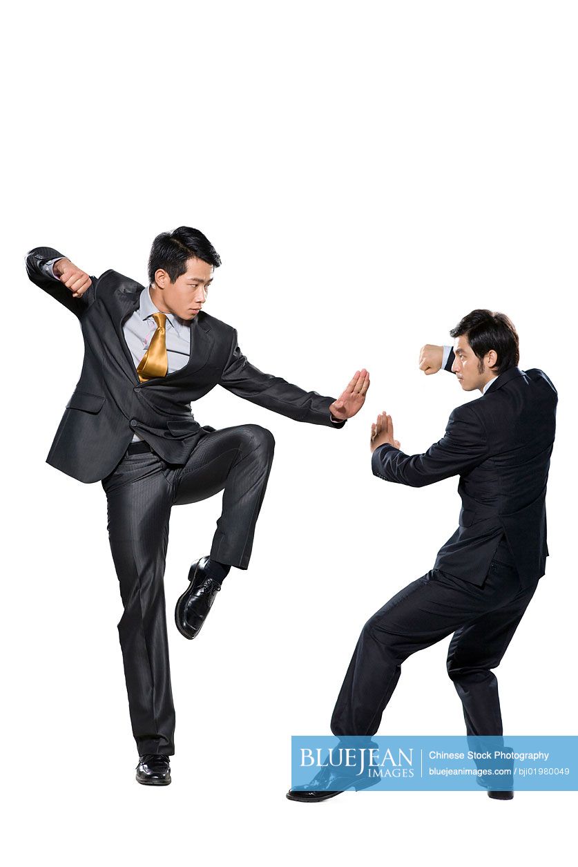 Two Chinese businessmen fighting on white background