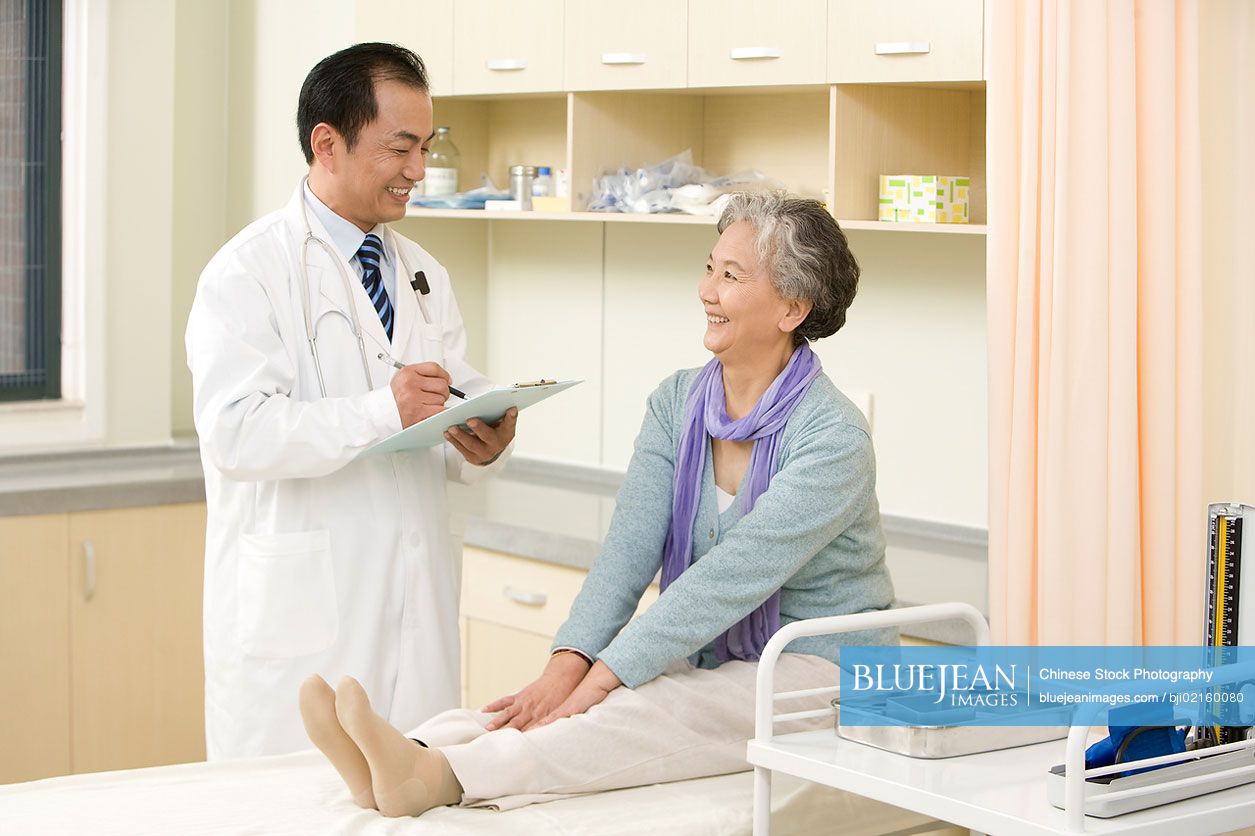 Chinese doctor examining senior woman