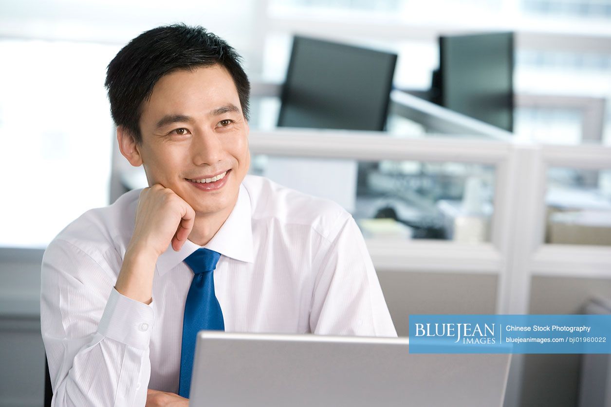 Chinese office worker at his desk