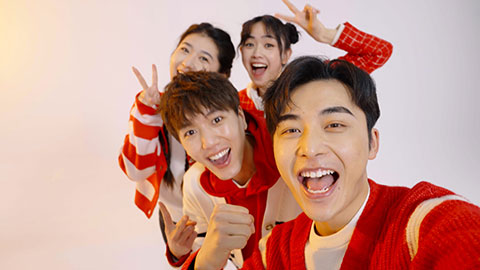 Young Chinese friends taking selfie