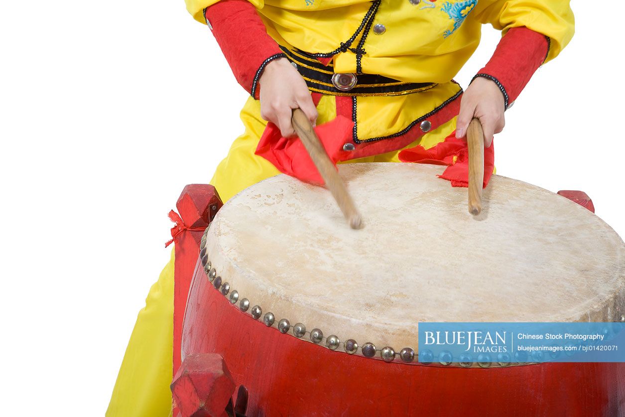 Close-up of man beating drum