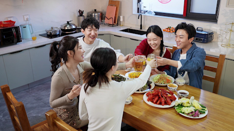 Young friends gathered around the table for a meal