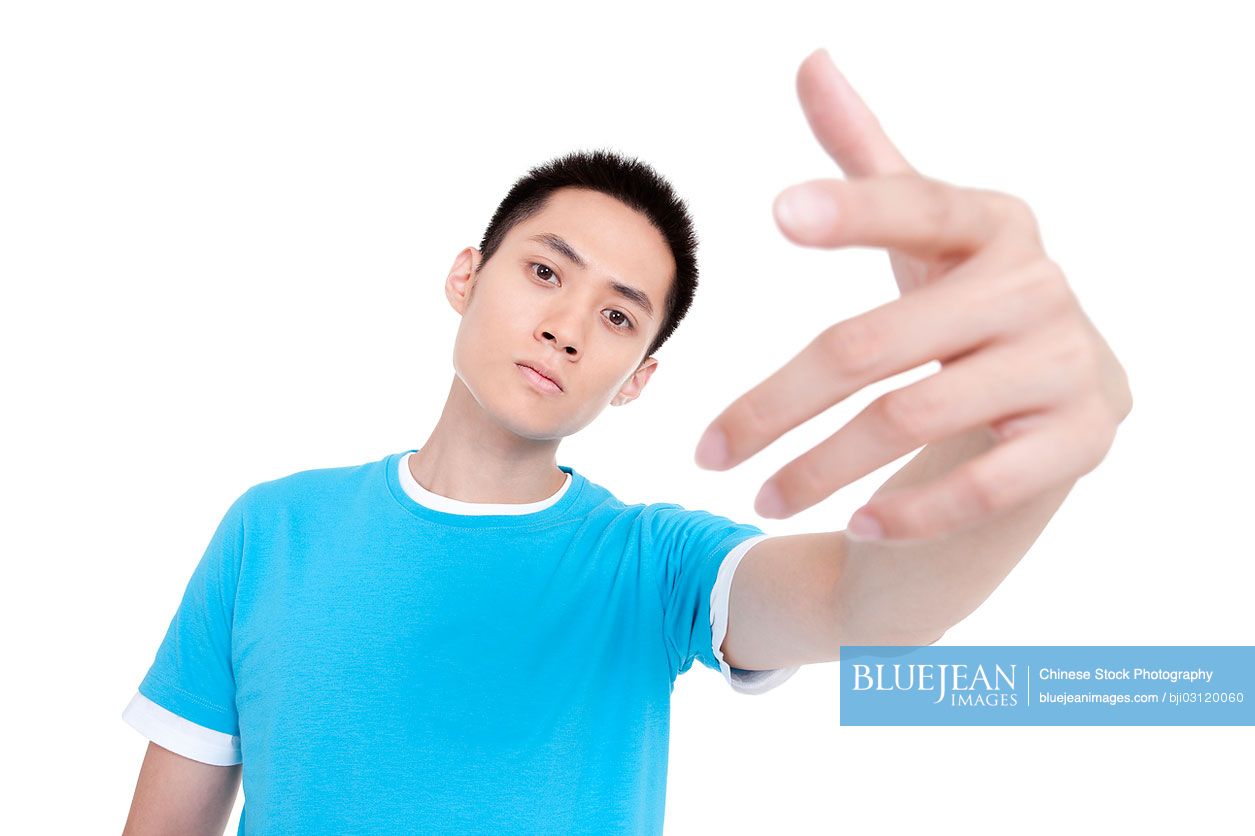 Young Chinese man making hip hop gesture