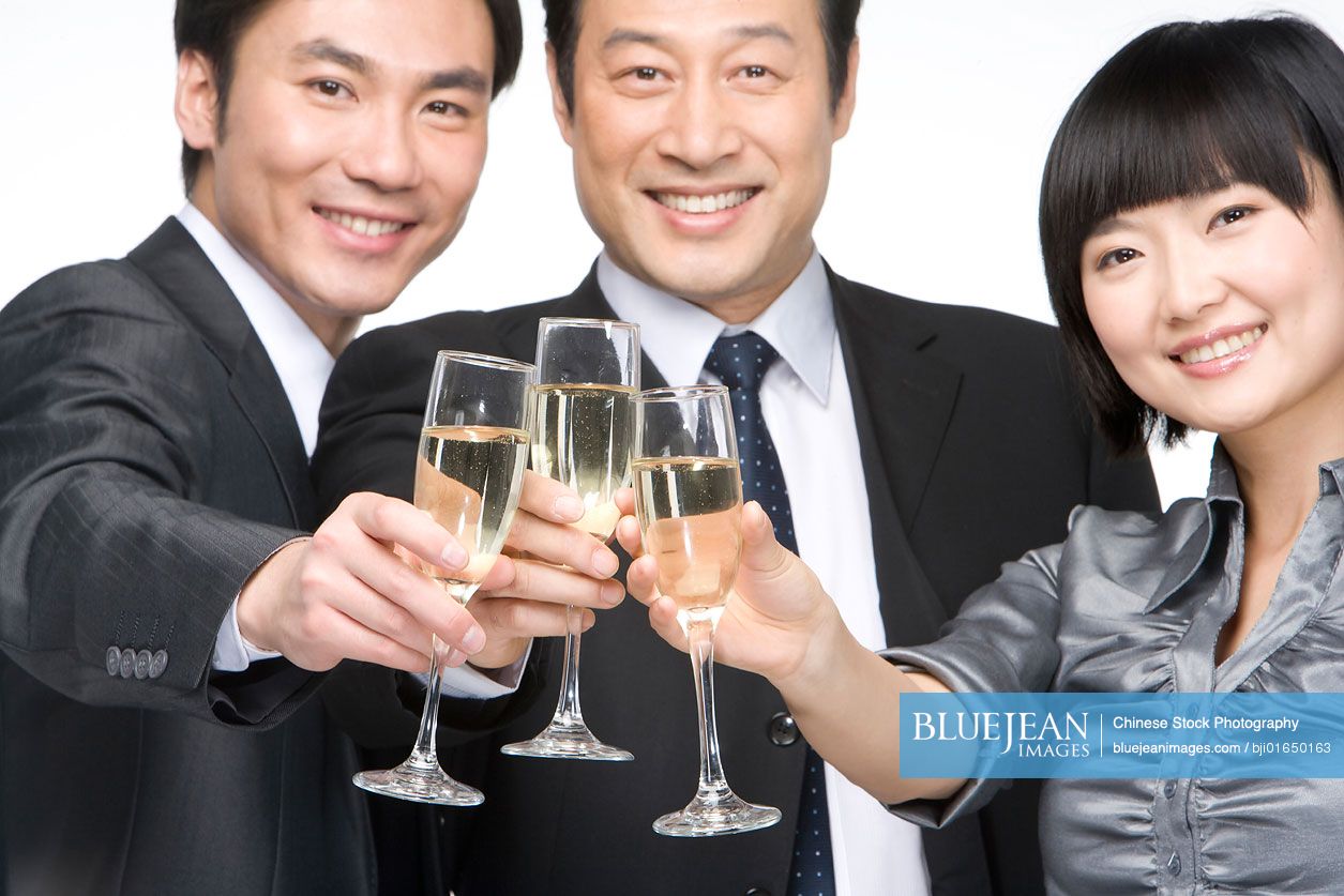 Chinese business team toasting with champagne