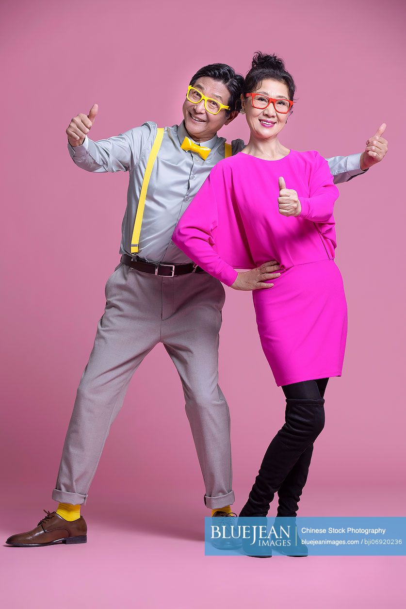 Studio shot of humorous senior Chinese couple