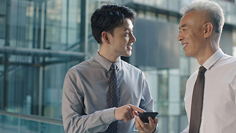 Confident Chinese business people talking in office building,4K