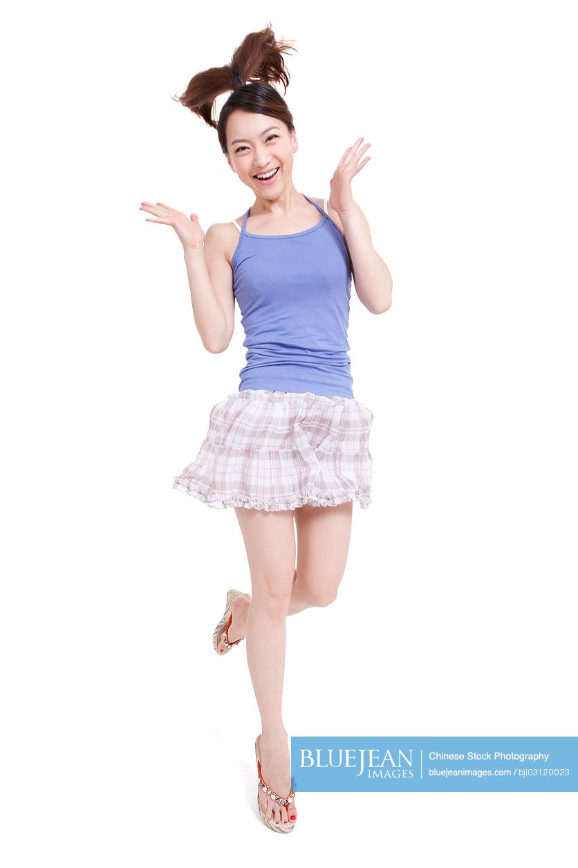 Excited young Chinese woman jumping