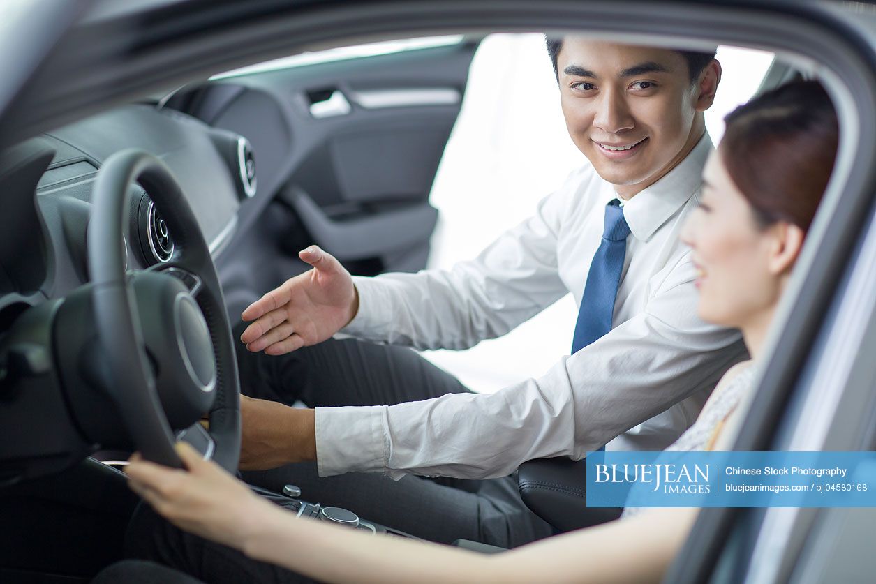 Young Chinese woman taking a test drive