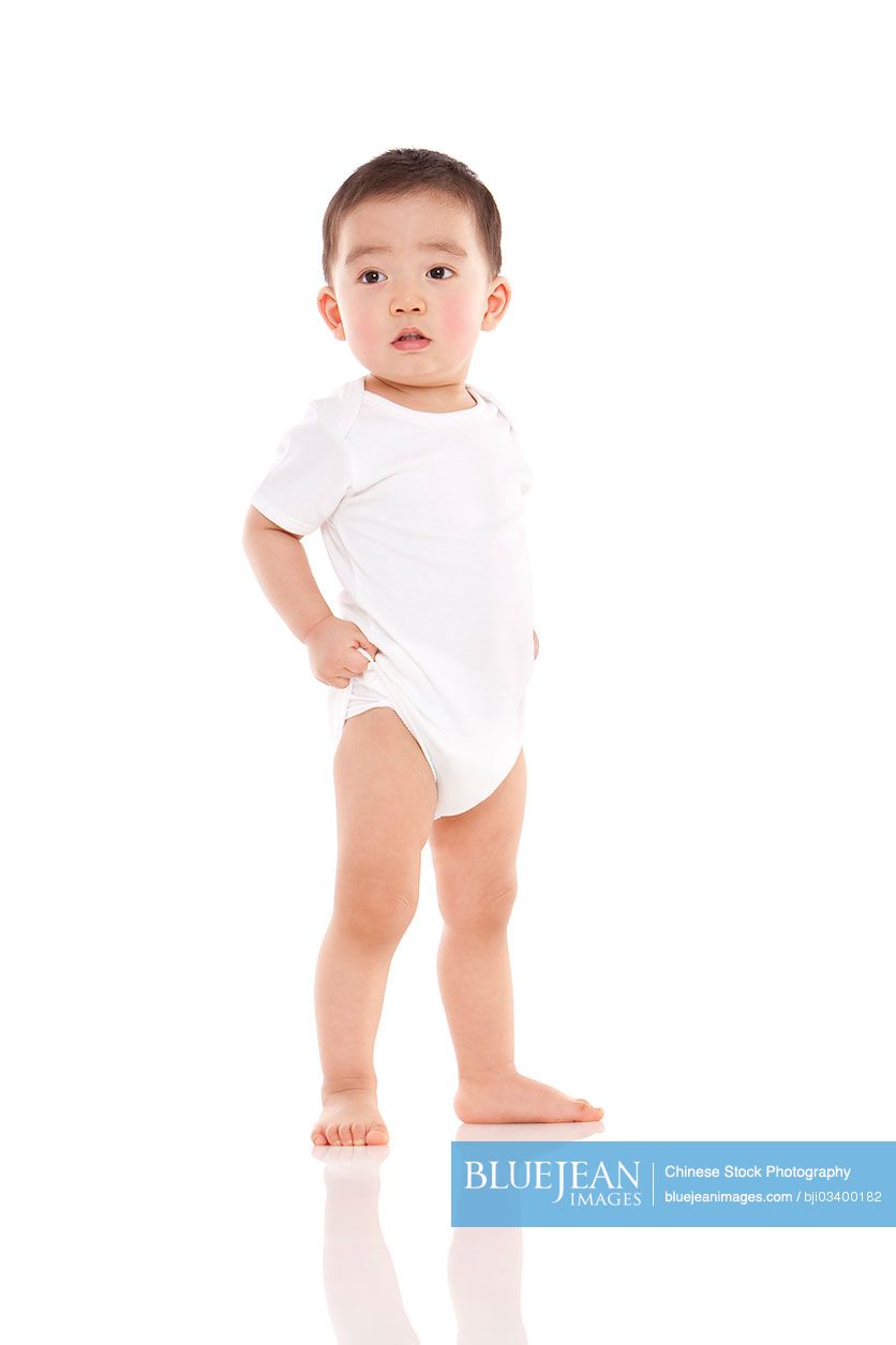 Cute Chinese baby boy standing hand on hip