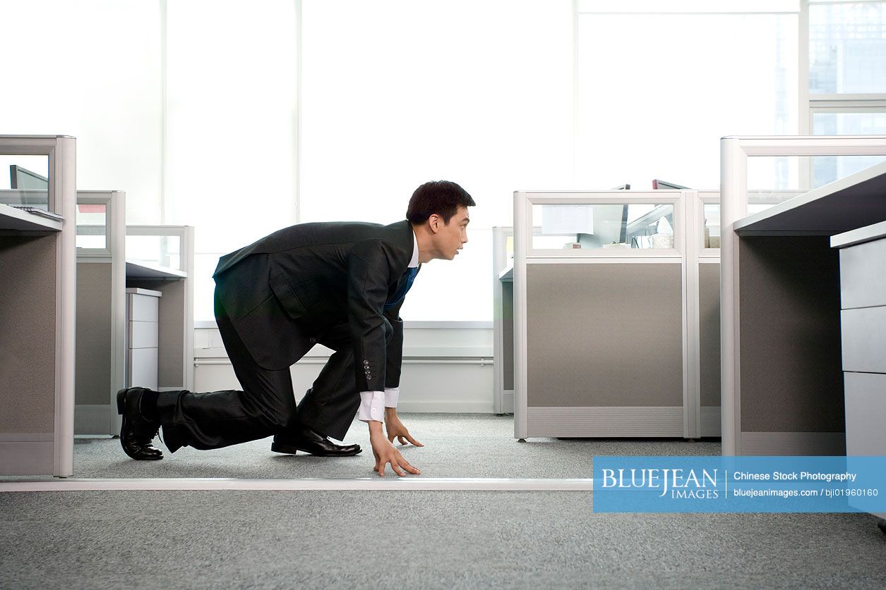 Chinese office worker ready to run in the office