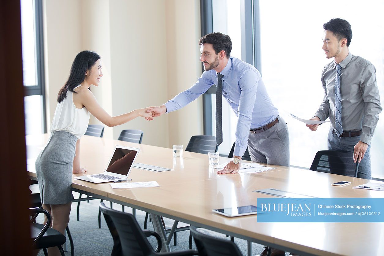 Chinese business people shaking hands