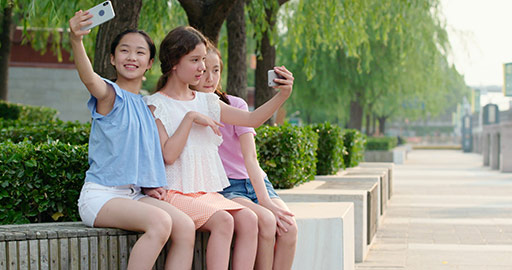 Teenagers taking selfie with smartphone outdoors,4K