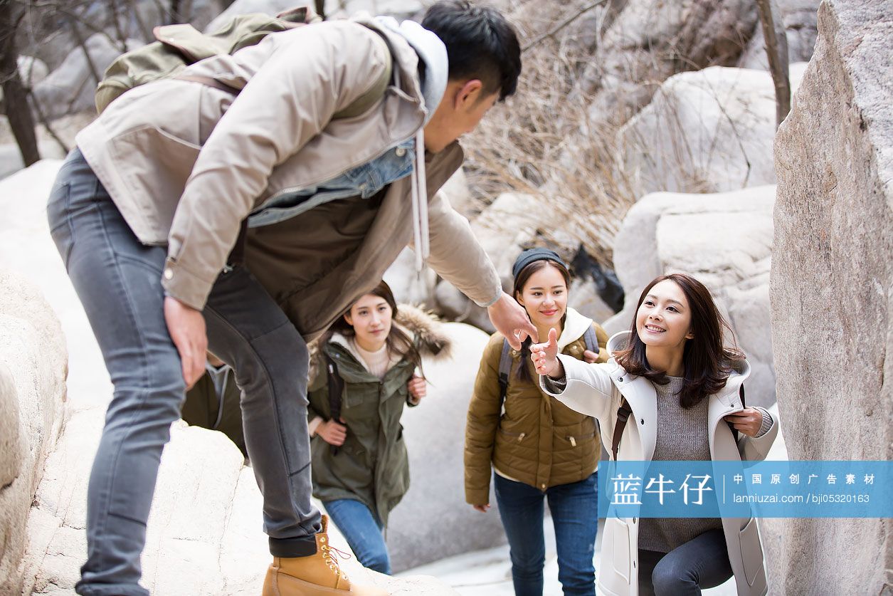 Happy young Chinese friends enjoying winter outing