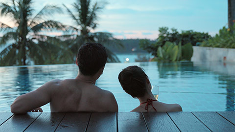 Happy young Chinese couple relaxing in swimming pool,4K