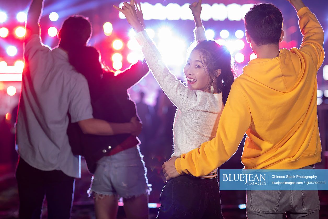 Happy young Chinese friends at music festival