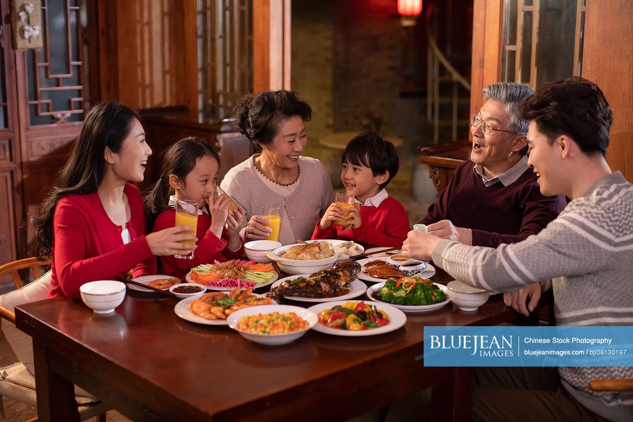 Happy Chinese family eating dinner for Chinese New Year