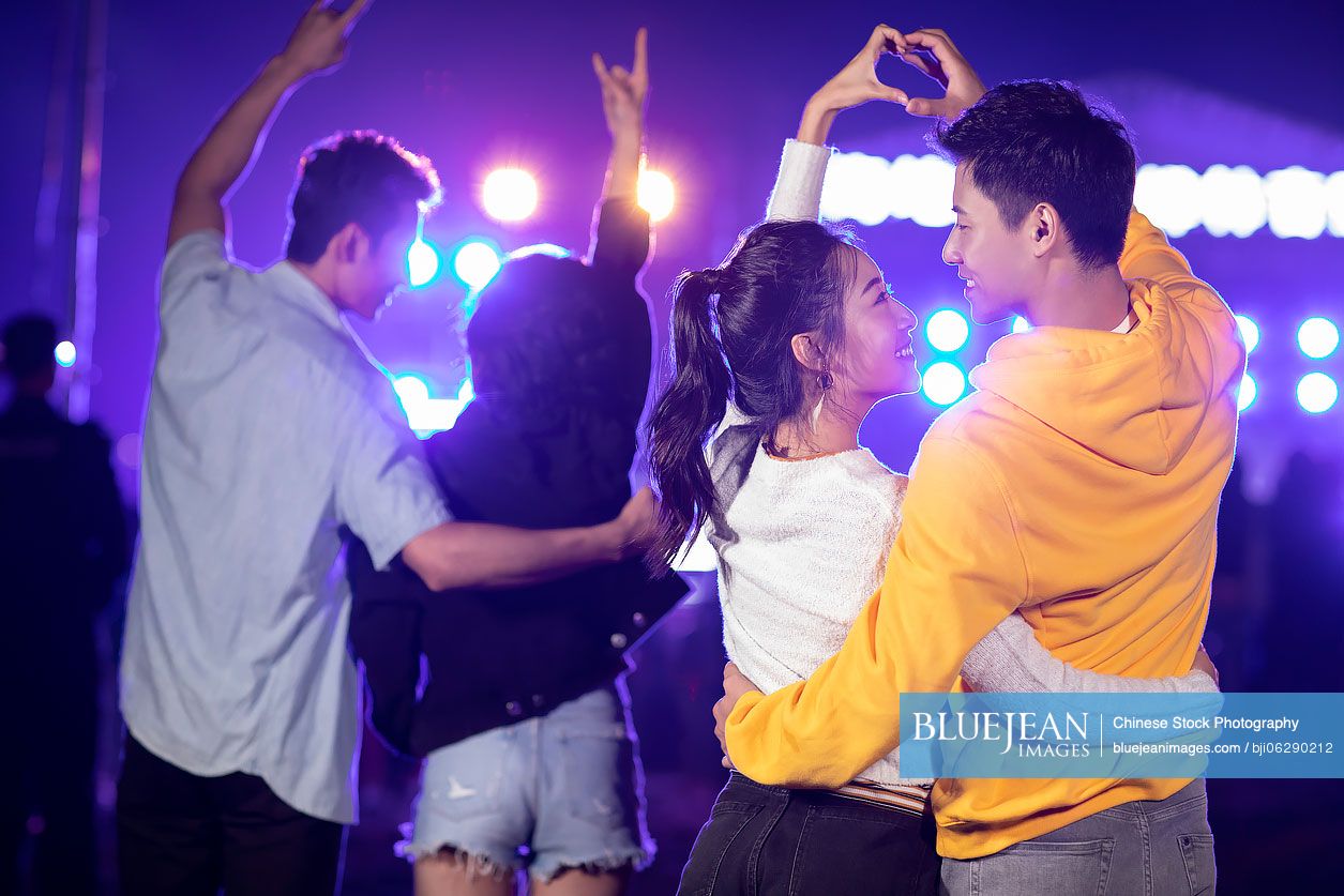 Happy young Chinese friends at music festival