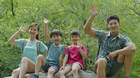 Happy young Chinese family hiking outdoors,4K