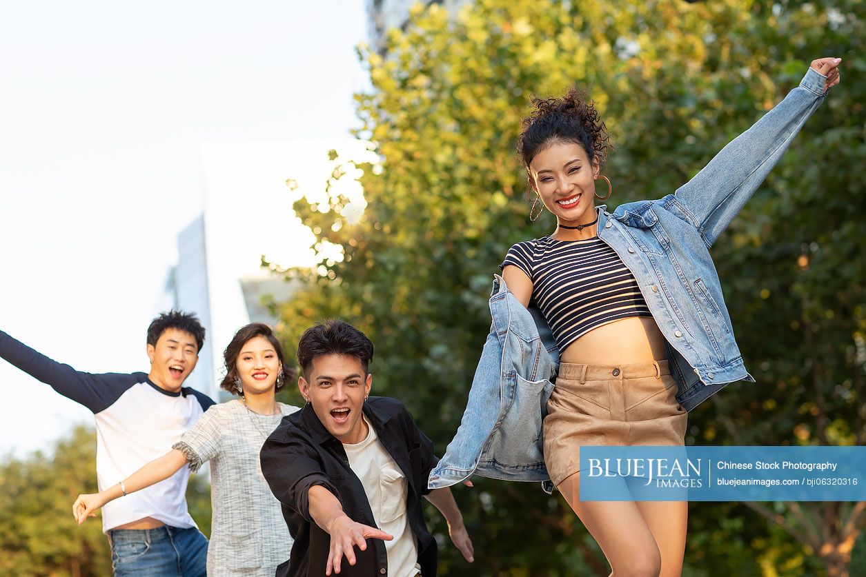 Fashionable young Chinese friends having fun on street
