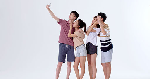 Cheerful young Chinese friends taking selfie with smartphone,4K