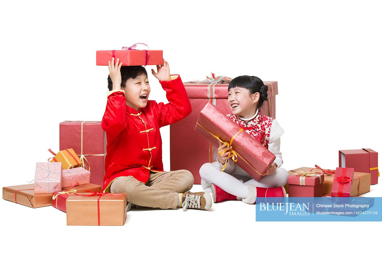 Happy children receiving many Chinese new year gifts