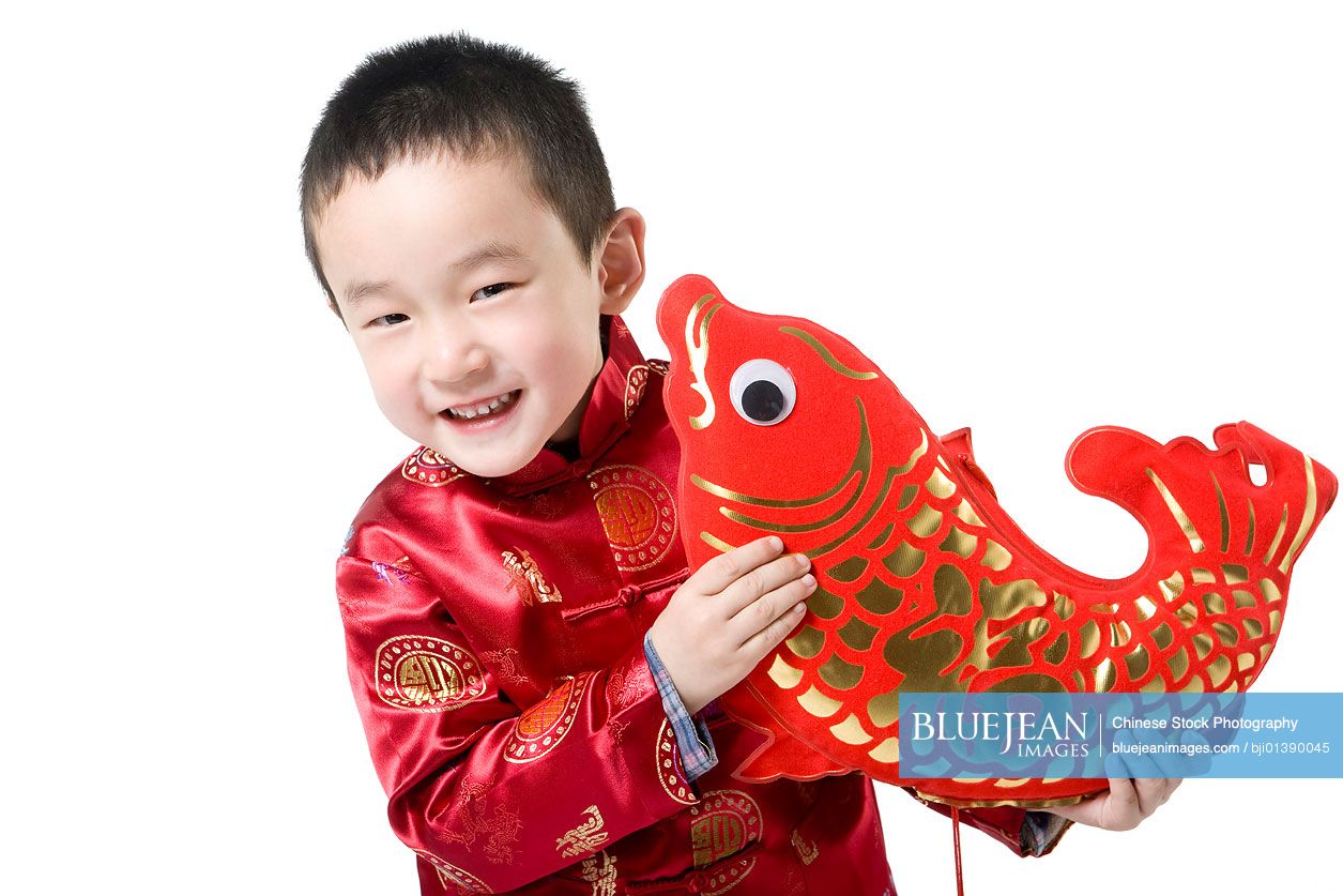 Boy in Chinese traditional clothes holding fish decoration-High-res stock  photo for download