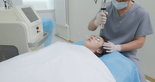Young Chinese woman receiving face treatment in hospital,4K