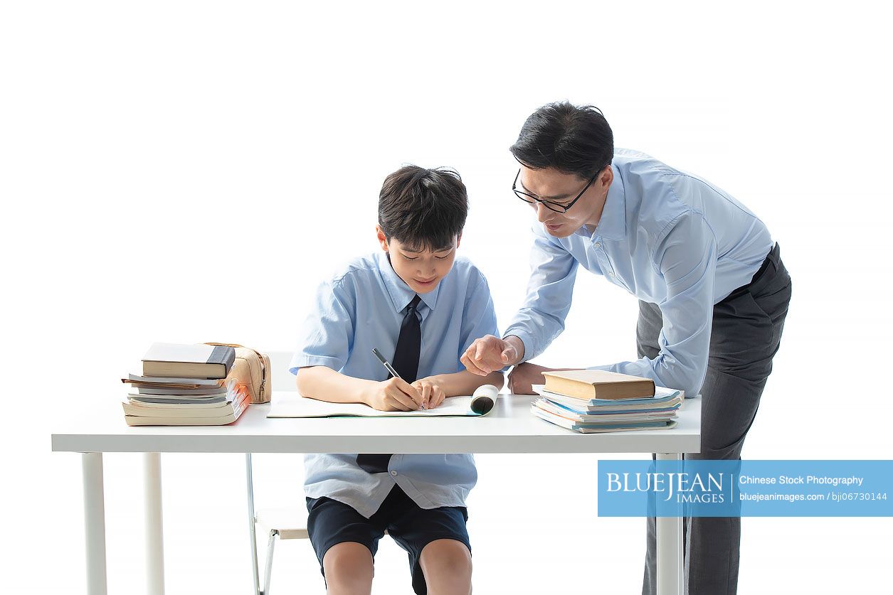 Chinese teacher helping boy with homework