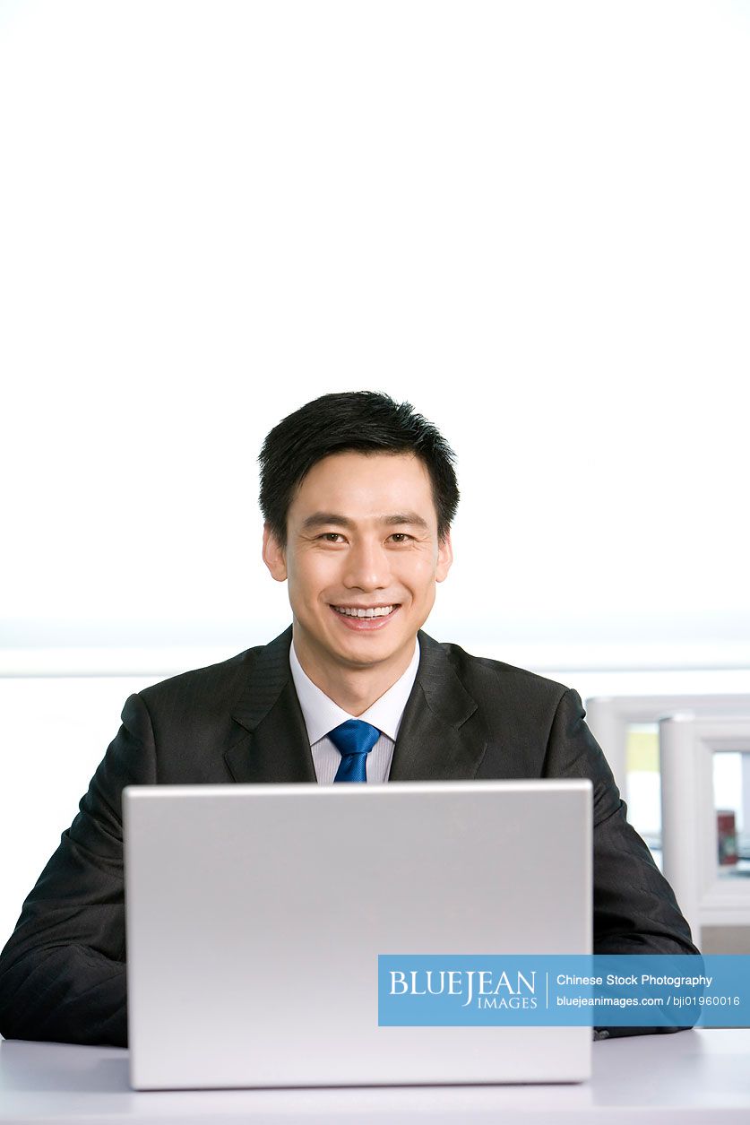 Chinese office worker at his desk